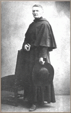 A photograph of Fr. d’Alzon, standing, with hat in hand, 1859- 1862